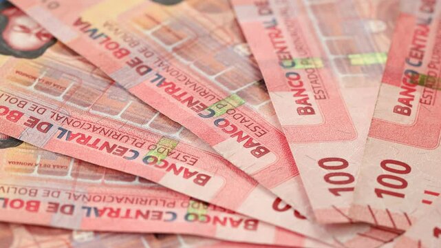 Bolivian money rotating, Lot of 100 bolivianos banknotes, Concept of financial success, lottery or big win. Bolivia monetary, Financial concept