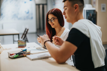 Two students engaged in a collaborative study session at a modern educational setting. They are discussing ideas, surrounded by study materials, fostering creativity and learning in a relaxed