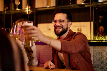Joyful Friends Toasting Together in a Cozy Bar Setting