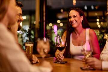 Joyful Friends Enjoying Drinks Together at a Cozy Bar