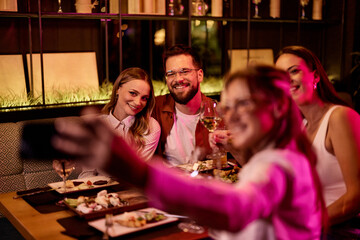 Friends Enjoying Dinner and Drinks at Cozy Restaurant