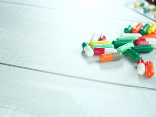 Lots of pills, capsules, blister packs on white background.