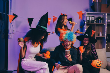 Joyful office Halloween party with coworkers in costumes, celebrating with drinks and laughter, fostering teamwork and festive spirit