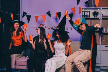 Joyful office Halloween party with coworkers in costumes, celebrating with drinks and laughter, fostering teamwork and festive spirit