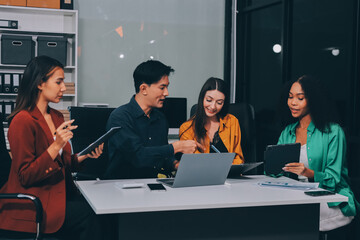 Young corporate employees sitting in office looking at laptop screen reading good news excited happy team diverse people celebrating victory win command success excellent result professional teamwork