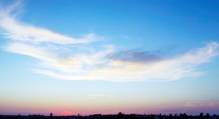 Blue sky with beautiful white clouds. Sky with cumulus and cirrocumulus clouds. Panoramic image of the sky.