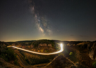 Cheile Dobrogei road with car light trails and Milky Way