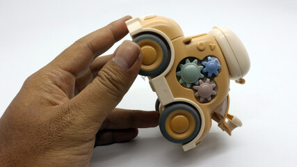 A brown children's toy car that looks very cute