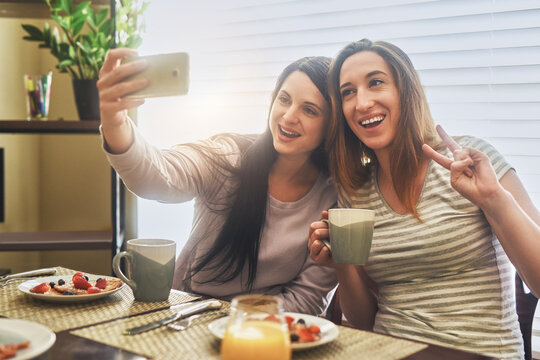 Happy couple, lesbian and selfie with peace sign for photography, picture or breakfast memory together at home. Young, female people or LGBTQ with smile, emoji or love for capture or moment at house - Powered by Adobe