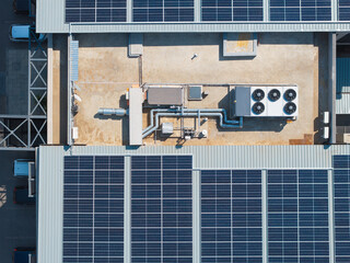 air conditioning industrial in top of a building roof, ac unit and pipe tubes with ventilation fans, solar panels © poco_bw