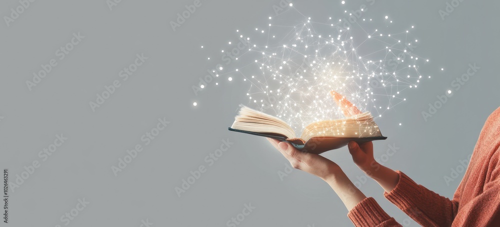 Wall mural A person holds an open book with magical sparkles emerging from it, symbolizing creativity.