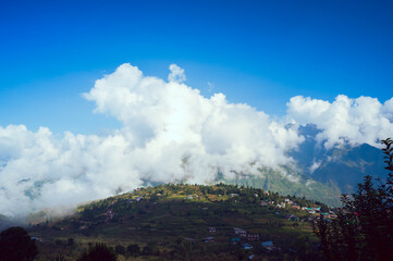 Fototapeta premium clouds over the mountains. Deori village. Sainj Valley, Eco Zone, Great Himalayan National Park, Himachal Pradesh, India. 