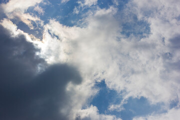 Fototapeta premium Ornamental clouds. Dramatic sky. Epic storm cloudscape. Soft sunlight. 