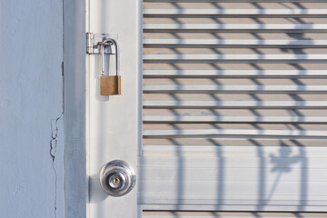 golden lock with locked gray metal door texture background