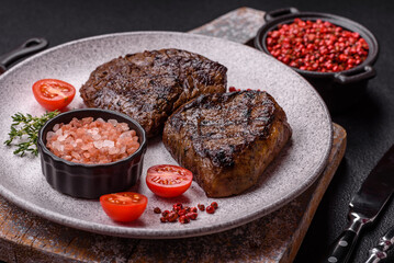 Juicy beef steak baked on the grill with salt, spices and herbs