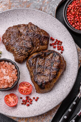 Juicy beef steak baked on the grill with salt, spices and herbs