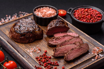 Juicy beef steak baked on the grill with salt, spices and herbs