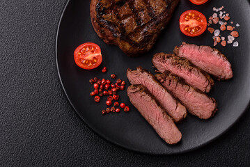 Juicy beef steak baked on the grill with salt, spices and herbs