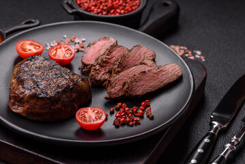 Juicy beef steak baked on the grill with salt, spices and herbs