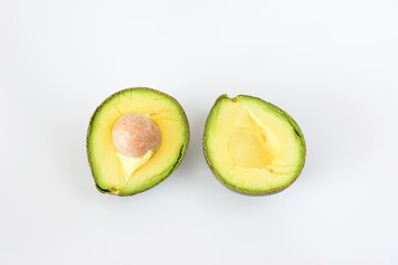 an avocado cut in half with a white background