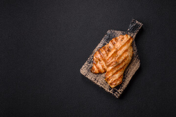 Juicy chicken fillet baked on the grill with salt, spices and herbs