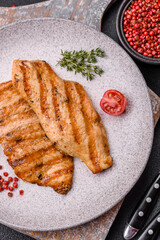 Juicy chicken fillet baked on the grill with salt, spices and herbs