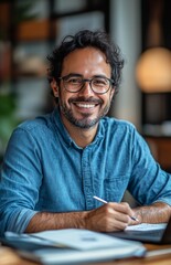 Man writing in a notebook while smiling in a cozy workspace with soft lighting