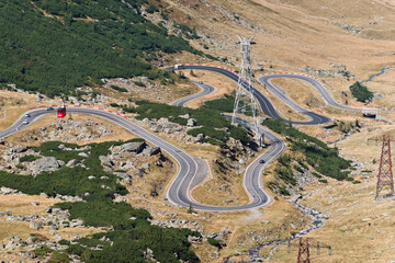 Transfăgărășan Highway, Romania - September 6, 2024: A breathtaking aerial view of the Transfagarasan Highway in Romania, showcasing its winding curves, scenic mountains, and dramatic landscapes.

