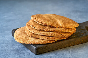 Pita wholegrain bread . Freshly baked arabic flat bread . Close up