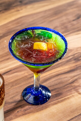 margarita in brightly colored glass on table