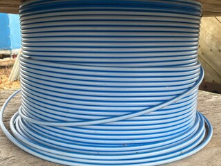 Wooden cable drum with plastic hoses