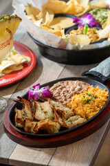 shrimp fajitas with sides and chips