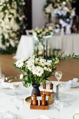 Luxurious restaurant. Luxurious interior, white tables, serving dishes and glasses for guests