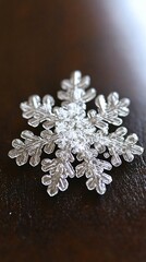 Fototapeta premium A single snowflake on a wooden surface.