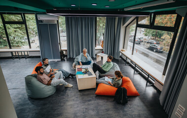 A professor interacts with a group of students in a contemporary learning environment, fostering...