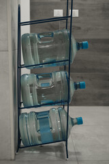 stand with three 20 liter water tanks in a residential building near an apartment, water delivery