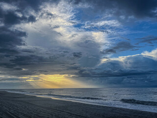 Heavenly Sun Beam Through the Clouds Onto Beach At Sunrise