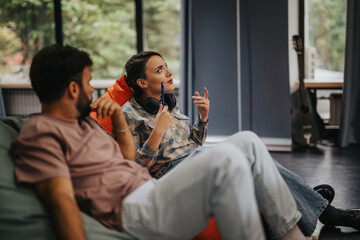 A young man and woman engage in a thoughtful discussion while relaxing in a modern room. The atmosphere is casual and intellectual, capturing a moment of connection and shared ideas.