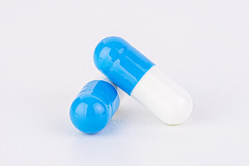 White and blue  pill capsule isolated on a white background