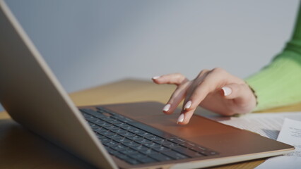 Businesswoman hands pressing laptop office closeup. Accountant using calculator