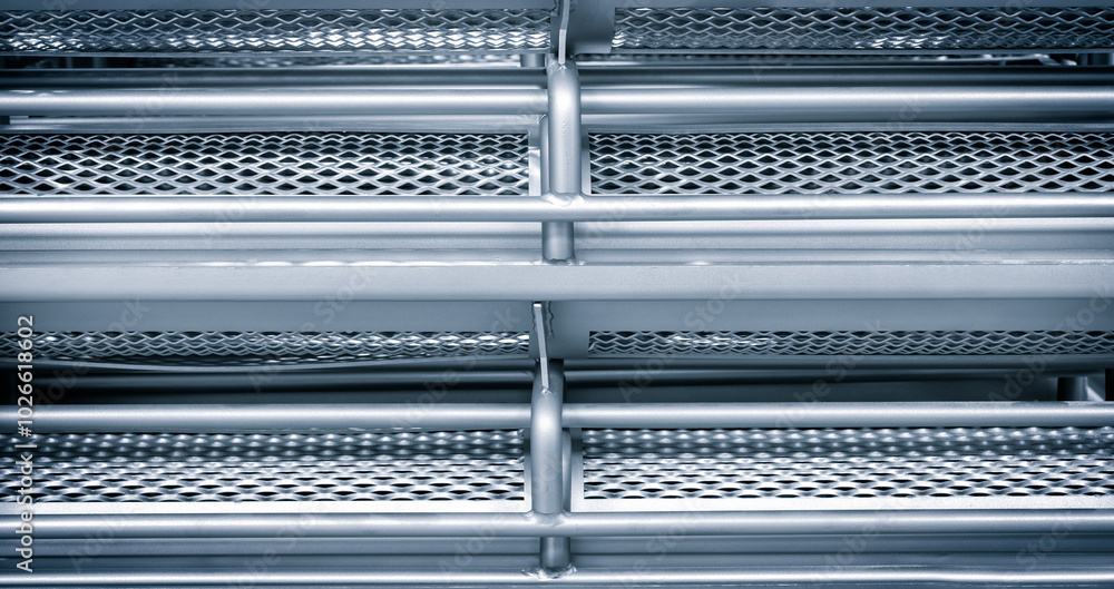 Aufkleber the image is of a metal structure with a lot of holes in it. the holes are arranged in a grid patter