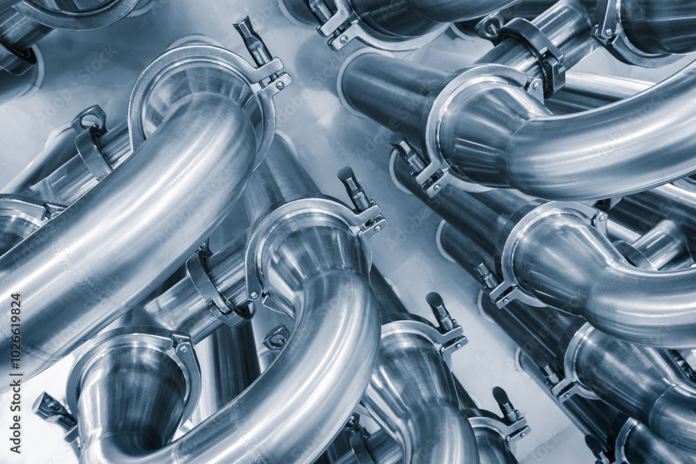 Poster dairy machine cooling radiator with a row of stainless steel metal pipes with silver trim. the pipes