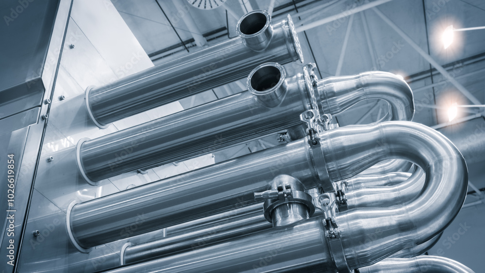 Poster dairy machine cooling radiator with a row of stainless steel metal pipes with silver trim. the pipes