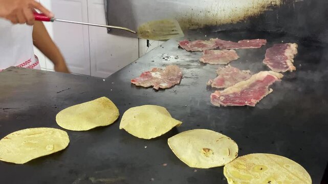 Chef prepares an order of tacos at the Tacos El Califa de Leon taco stand in Mexico City, Mexico.