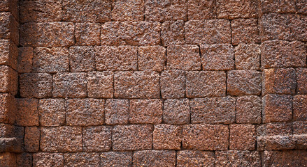 Ancient laterite brick wall for abstract seamless background and texture. beautiful patterns, space for work, close up.