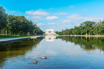 World famous Lincoln Memorial reflected in the water under a cloudy sky