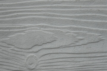 Obraz premium A wooden surface with a grainy texture. The wood appears to be unfinished, with a rough and uneven surface. Scene is somewhat rugged and natural, evoking a sense of raw, untouched beauty