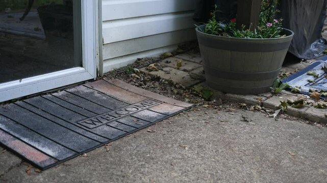 A man casually steals a package from a residential home