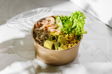 bowl with shrimp and quinoa in an ecological box