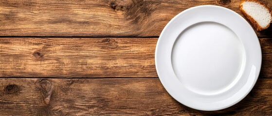  A white plate sits atop a wooden table Next to it rests a separate plate bearing a single slice of bread